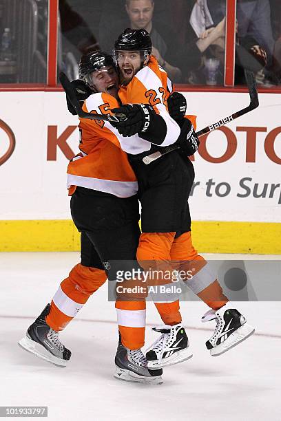 Matt Carle and Ville Leino of the Philadelphia Flyers celebrate after teammate Scott Hartnell scored a goal in the third period against the Chicago...