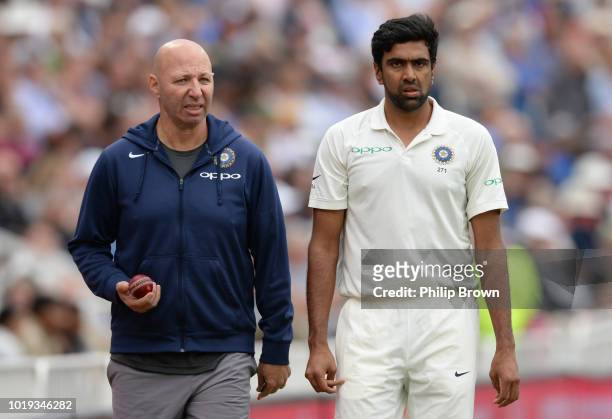 Ravi Ashwin of India walks around the ground with physiotherapist Patrick Farhart during the second day of the 3rd Specsavers Test Match between...