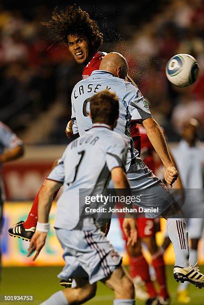 Conor Casey of the Colorado Rapids heads the ball past Wilman Conde of the Chicago Fire to score a goal in front of teammate Drew Moor in an MLS...