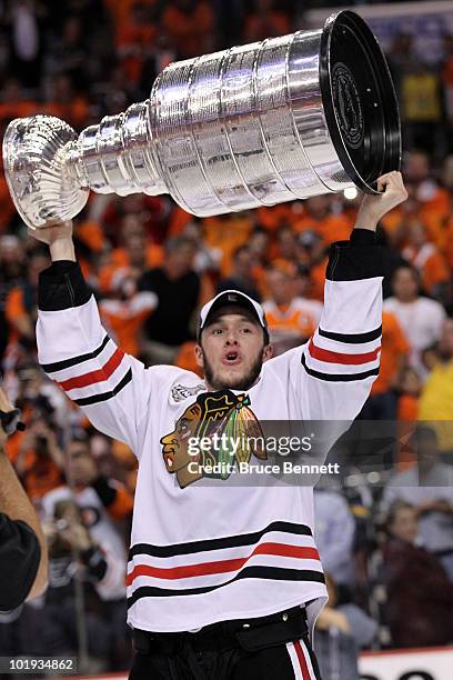 Jonathan Toews of the Chicago Blackhawks hoists the Stanley Cup after teammate Patrick Kane scored the game-winning goal in overtime to defeat the...