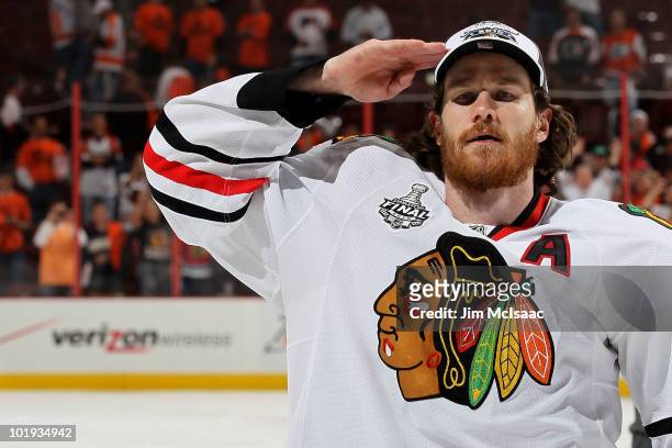 Duncan Keith of the Chicago Blackhawks salutes after the Blackhawks defeated the Philadelphia Flyers 4-3 in overtime and win the Stanley Cup in Game...