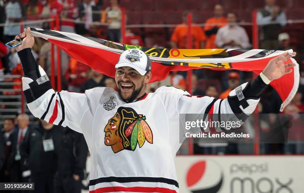 Dustin Byfuglien the Chicago Blackhawks skates with a Blackhawks flag after defeating the Philadelphia Flyers 4-3 to win the Stanley Cup in Game Six...