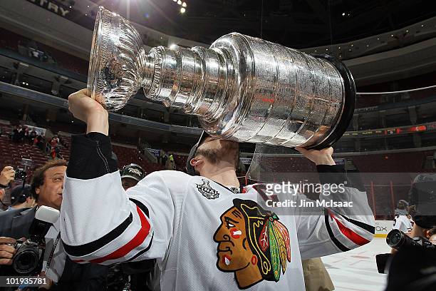 Jonathan Toews of the Chicago Blackhawks kisses the Stanley Cup after teammate Patrick Kane scored the game-winning goal in overtime to defeat the...