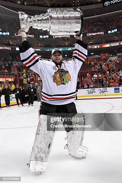 Antti Niemi of the Chicago Blackhawks hoists the Stanley Cup after teammate Patrick Kane scored the game-winning goal in overtime to defeat the...