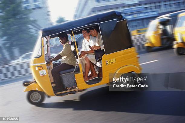 india, madras, couple travelling in auto rickshaw (blurred motion) - tuk tuk stock pictures, royalty-free photos & images