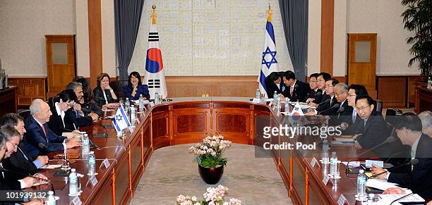 South Korean President Lee Myung-Bak talks with Israeli President Shimon Peres during their meeting at the presidential blue house on June 10, 2010...