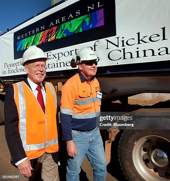 Norman Moore, Western Australia's mines and petroleum minister, left, and John Bower, Cosmic Boy nickel concentrate plant manager, walk past enclosed...