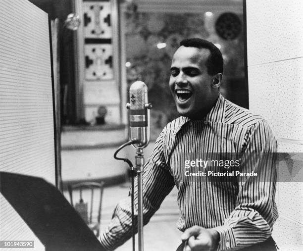 American singer Harry Belafonte performing in a recording studio, circa 1957.