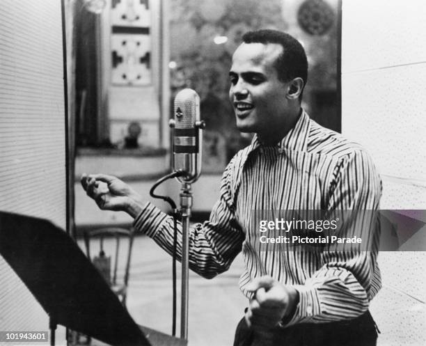 American singer Harry Belafonte performing in a recording studio, circa 1957.