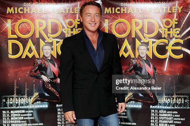 Irish step dancer Michael Flatley poses in front of the placard for the new 'Lord of the Dance' tour on June 10, 2010 in Munich, Germany.