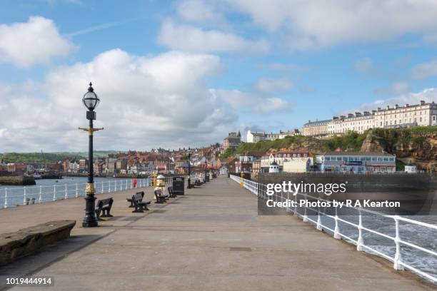 west pier in the seaside town of whitby, north yorkshire, england - beach england stock pictures, royalty-free photos & images