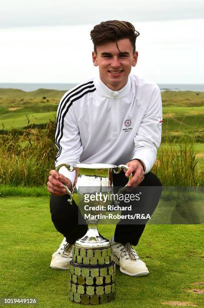 Conor Gough of England poses with the trophy following his victory during the final of the Boys Amateur Championship at Royal Portrush Golf Club on...