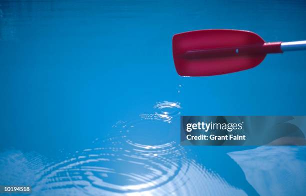 canoe oar making droplets in lake - oar stock pictures, royalty-free photos & images