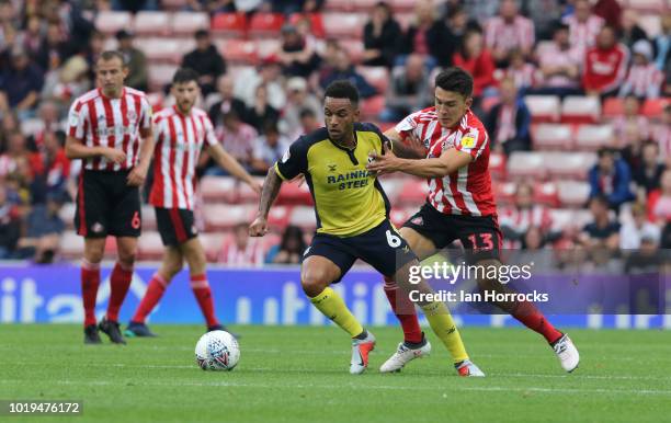 Luke O'Nein of Sunderland challenges Funso Ojo of Scunthorpe during the Sky Bet League One match between Sunderland and Scunthorpe United at Stadium...