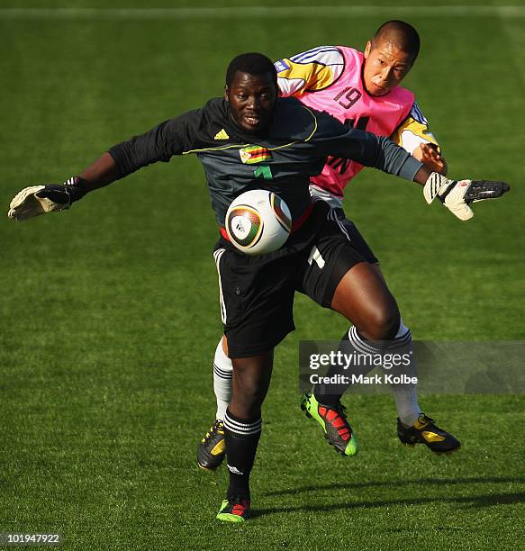 Edmore Sibanda of Zimbabwe and Takayuki Morimoto of Japan compete for the ball during a practice match between Japan and Zimbabwe at Outeniqua...