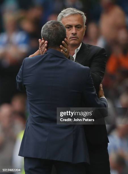 Manager Jose Mourinho of Manchester United congratulates Manager Chris Hughton of Brighton and Hove Albion after the Premier League match between...