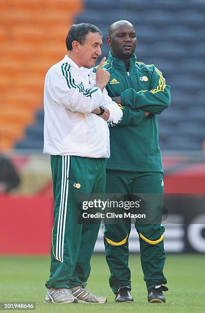 Carlos Alberto Parreira head coach of South Africa speaks with assistant Pitso Mosimane during a South Africa training session ahead of the 2010 FIFA...