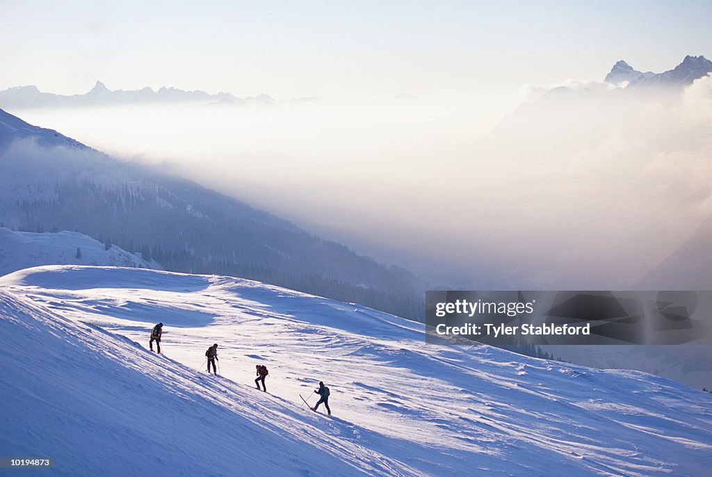 Skiers preparing to descend slope, elevated view