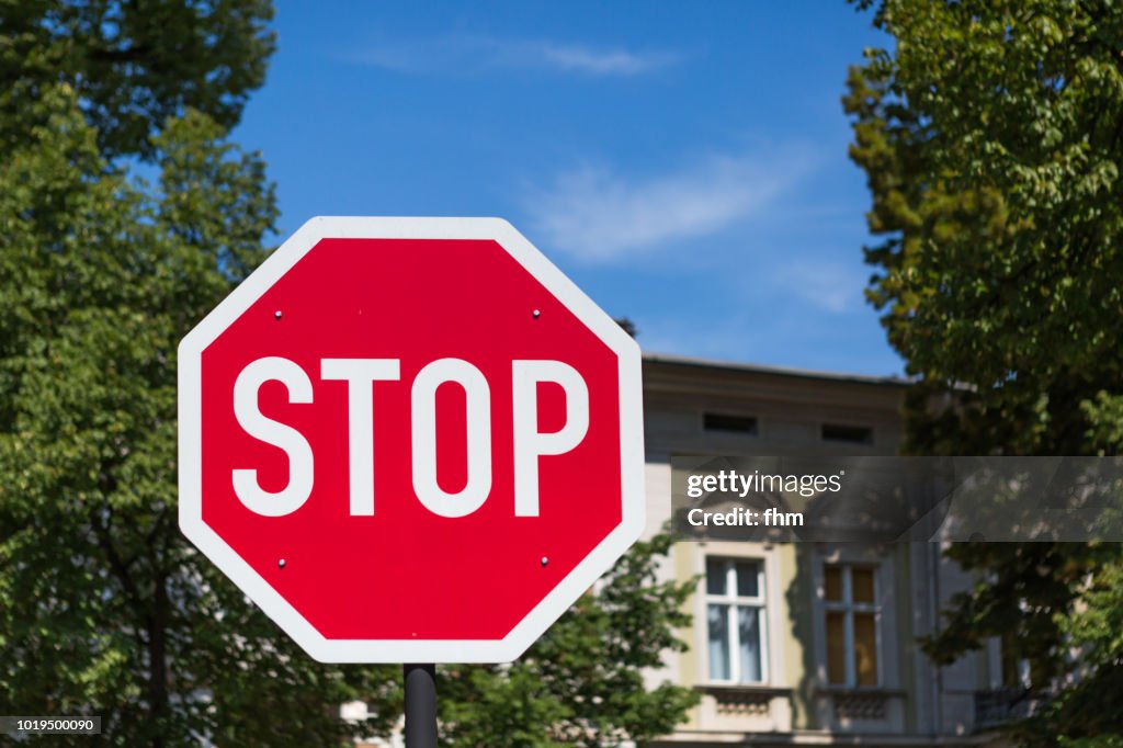 STOP-sign with facade in the background