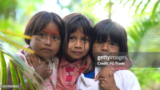 three cute children girls embracing - amazon jungle girls stock pictures, royalty-free photos & images