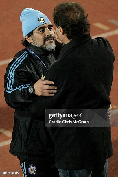Argentina's head coach Diego Maradona talks with former footballer Oscar Ruggeri after a team training session on June 10, 2010 in Pretoria, South...