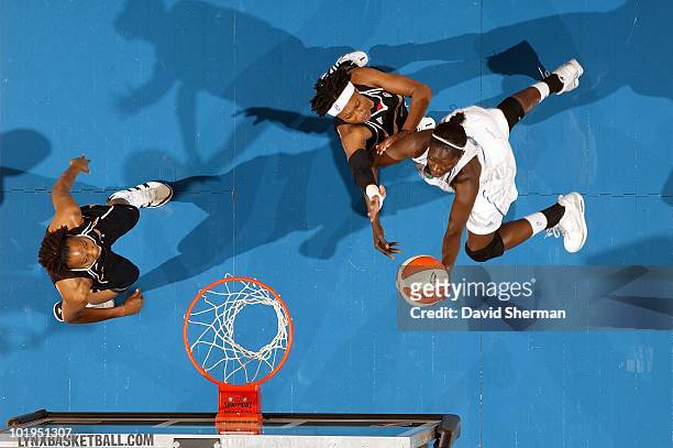 Hamchetou Maiga-Ba of the Minnesota Lynx goes to the basket against Alexis Hornbuckle and Chante Black of the Tulsa Shock during the WNBA game on May...