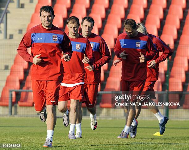 Serbia's midfielder Dejan Stankovic runs with teammates during a team training session at the Rand stadium in Johannesburg on June 10, 2010. Serbia's...