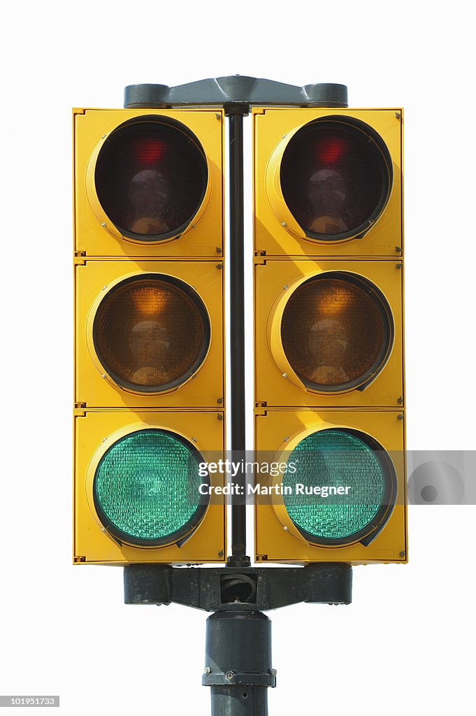 Green signal on traffic light, white background.