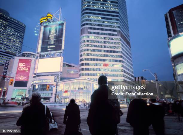 people waiting to cross dundas square in toronto. - toronto sign stock pictures, royalty-free photos & images