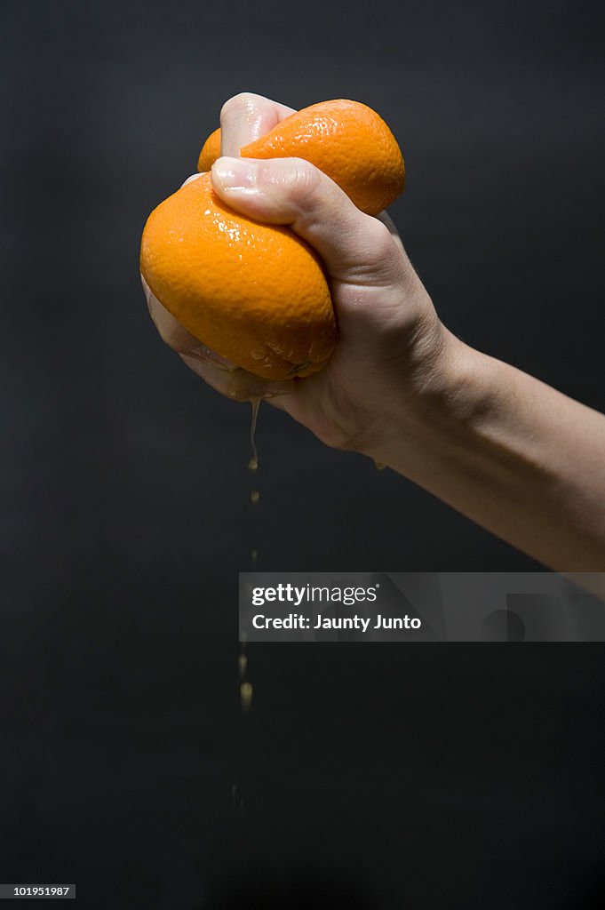 Orange crushed by hand