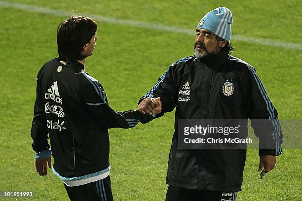 Argentina's head coach Diego Maradona talks with Lionel Messi at the completion of a team training session on June 10, 2010 in Pretoria, South Africa.