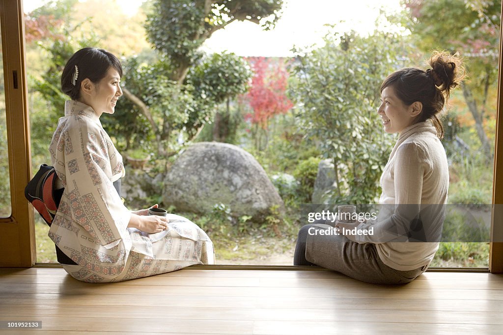 Two Japanese women talking on the veranda