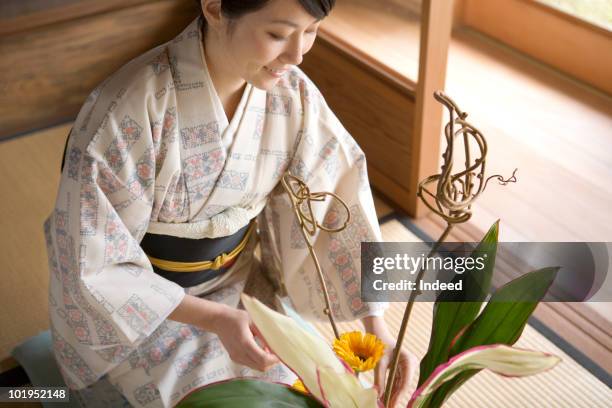 japanese woman wearing kimono arranging flowers - wabi sabi stock pictures, royalty-free photos & images