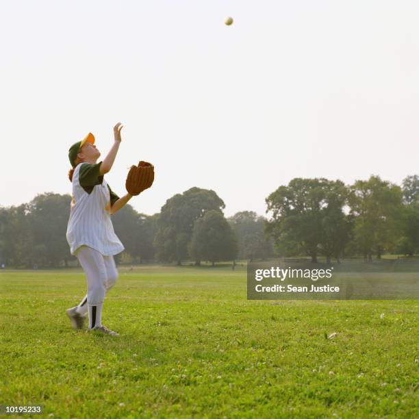 teenage girl (14-16) softball player catching ball, profile - girls softball stock pictures, royalty-free photos & images