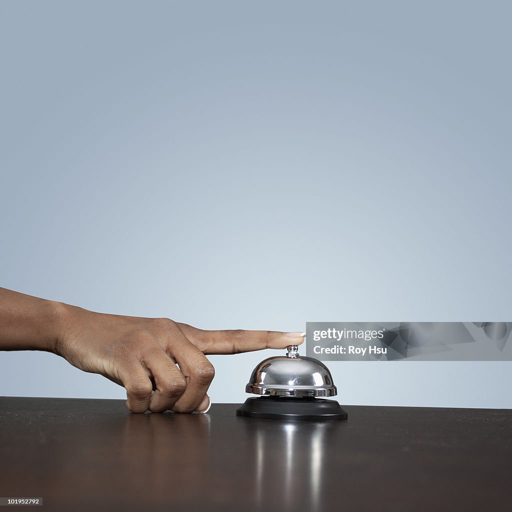 African American Woman ringing service bell