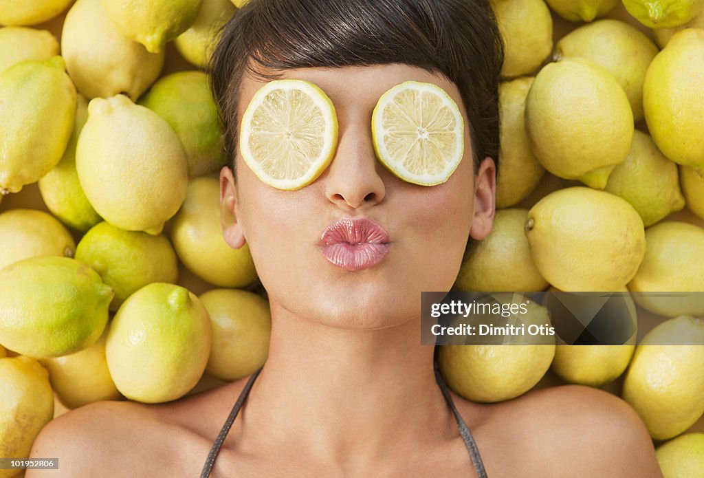 Portrait of young woman between lemons 