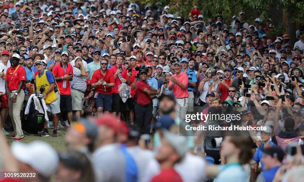 Tiger Woods of the United States plays a shot on the ninth hole during the final round of the 2018 PGA Championship at Bellerive Country Club on...