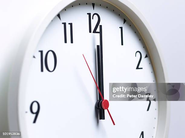 clock face at midday - midnight stock pictures, royalty-free photos & images