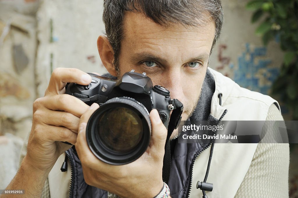 Photographer looking over lens.