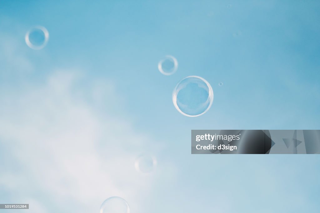 Bubbles floating in the air against clear blue sky