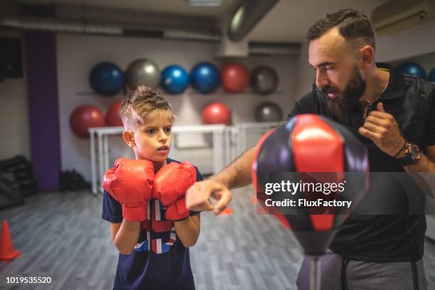 child doing a private training with his personal training - kid boxing stock pictures, royalty-free photos & images