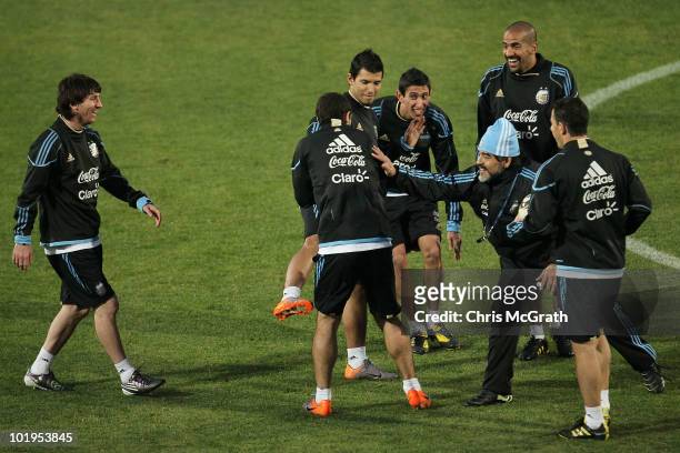 Argentina's head coach Diego Maradona and other players push and slap captain Javier Mascherano after he let the ball hit the ground in a passing...