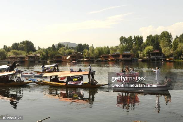 Kashmiri boatmen during a boat rally at Dal Lake as a mark to protest against challenging of Article 35-A on August 19, 2018 in Srinagar, India.