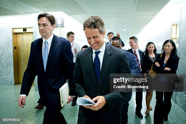 Timothy Geithner, U.S. Treasury secretary, center, walks in the U.S. Capitol after testifying at a Senate Finance Committee hearing in Washington,...