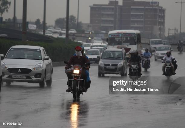 Traffic moving slowly on Delhi-Gurgaon Expressway as it drizzles near Signature Tower Chowk on August 19, 2018 in Gurugram, India.