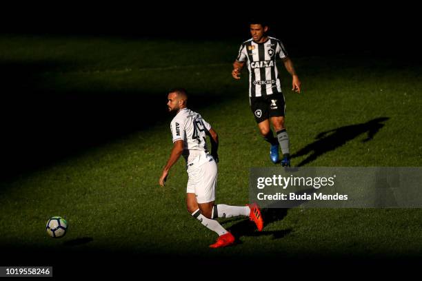 Renatinho of Botafogo struggles for the ball with Jose Welison of Atletico during a match between Botafogo and Atletico MG as part of Brasileirao...