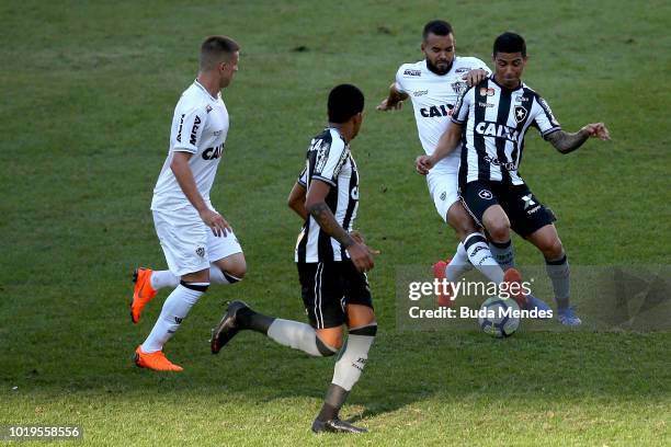 Renatinho of Botafogo struggles for the ball with Jose Welison of Atletico during a match between Botafogo and Atletico MG as part of Brasileirao...