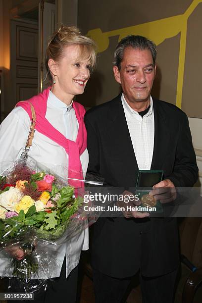 Novelist Paul Auster and his wife US writer Siri Hustvedt pose during an award ceremony after he received the "Grand Vermeil" medal from the mayor of...