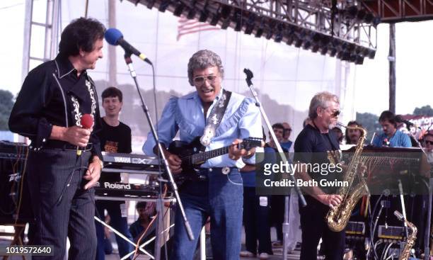 Country singer and songwriters Johnny Cash and Carl Perkins perform on the Polygram Fanfair show June 10, 1986 in Nashville, Tennessee.