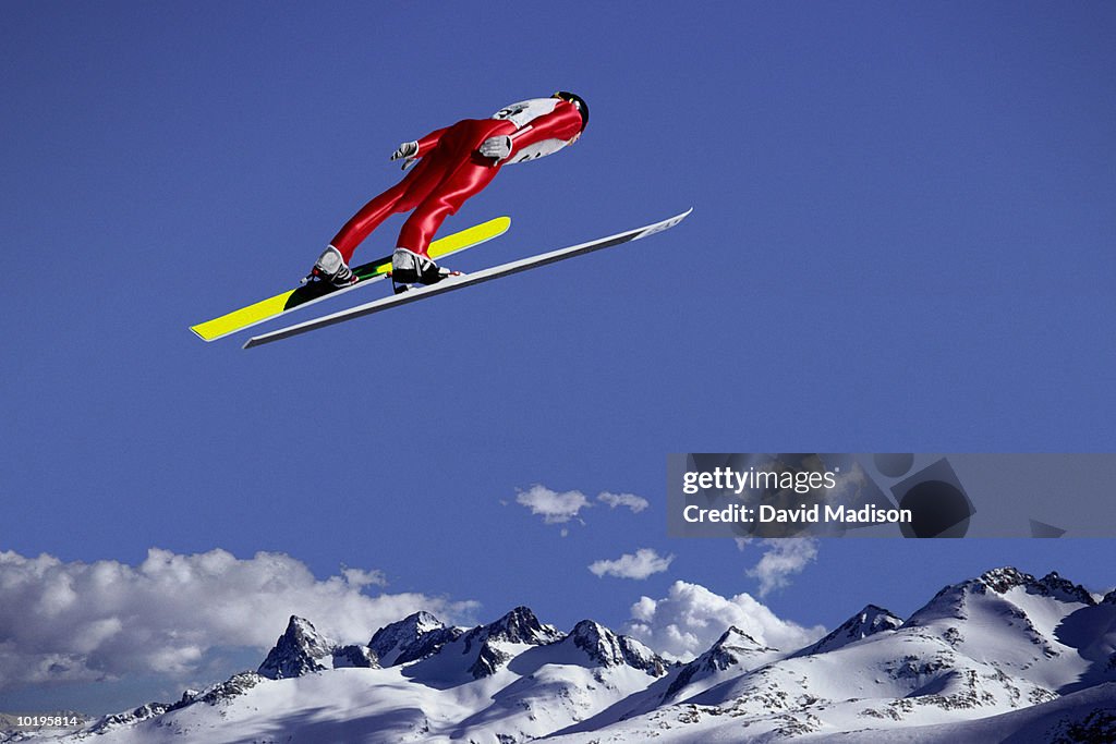 Downhill skier jumping, rear view (digital composite)
